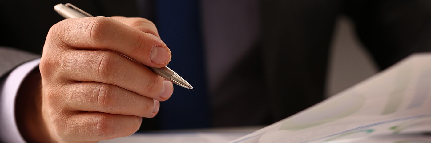 Male hand in suit hold silver pen in office